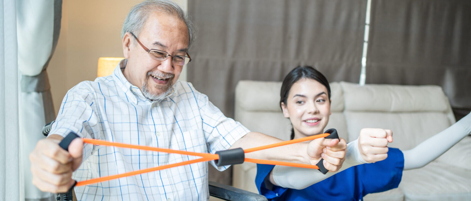 Older man working with a physical therapist on an exercise at home